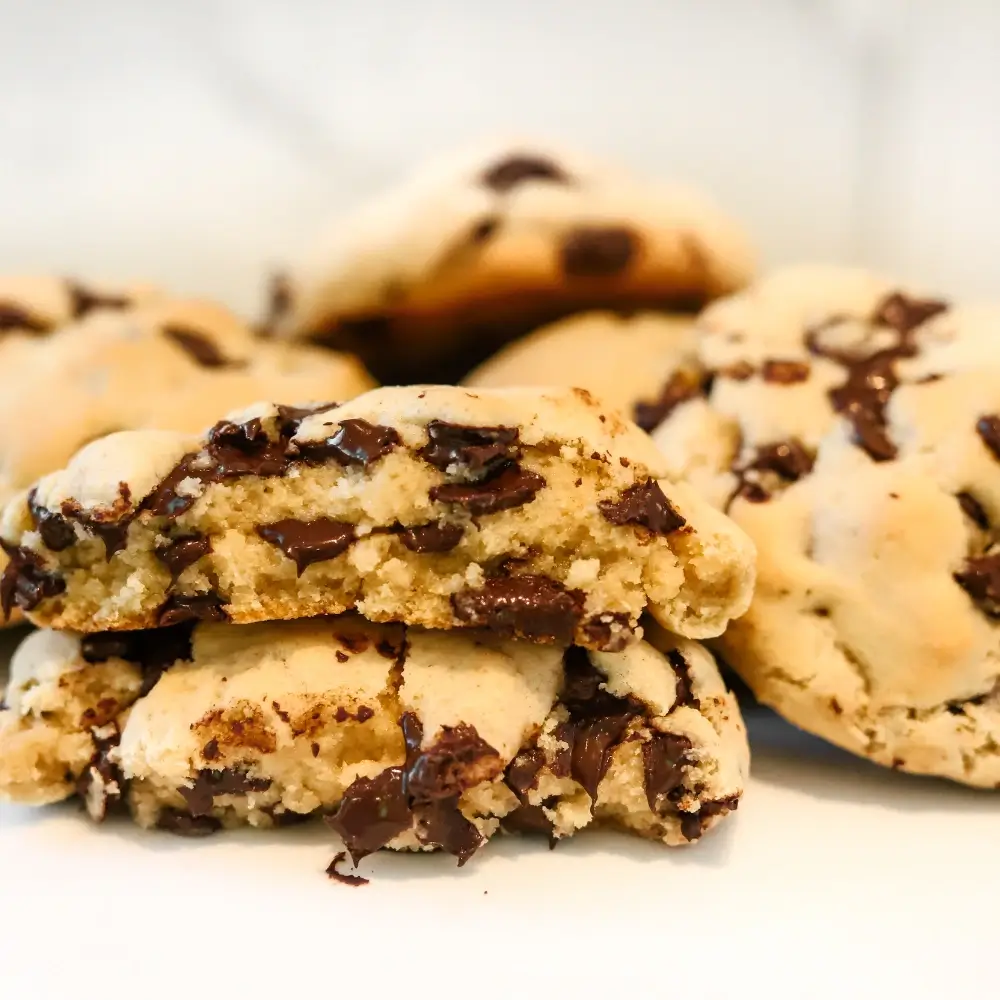 Chocolate Chip Cookie Recipe: Freshly baked with golden edges and gooey chocolate chips, placed on a cooling rack.