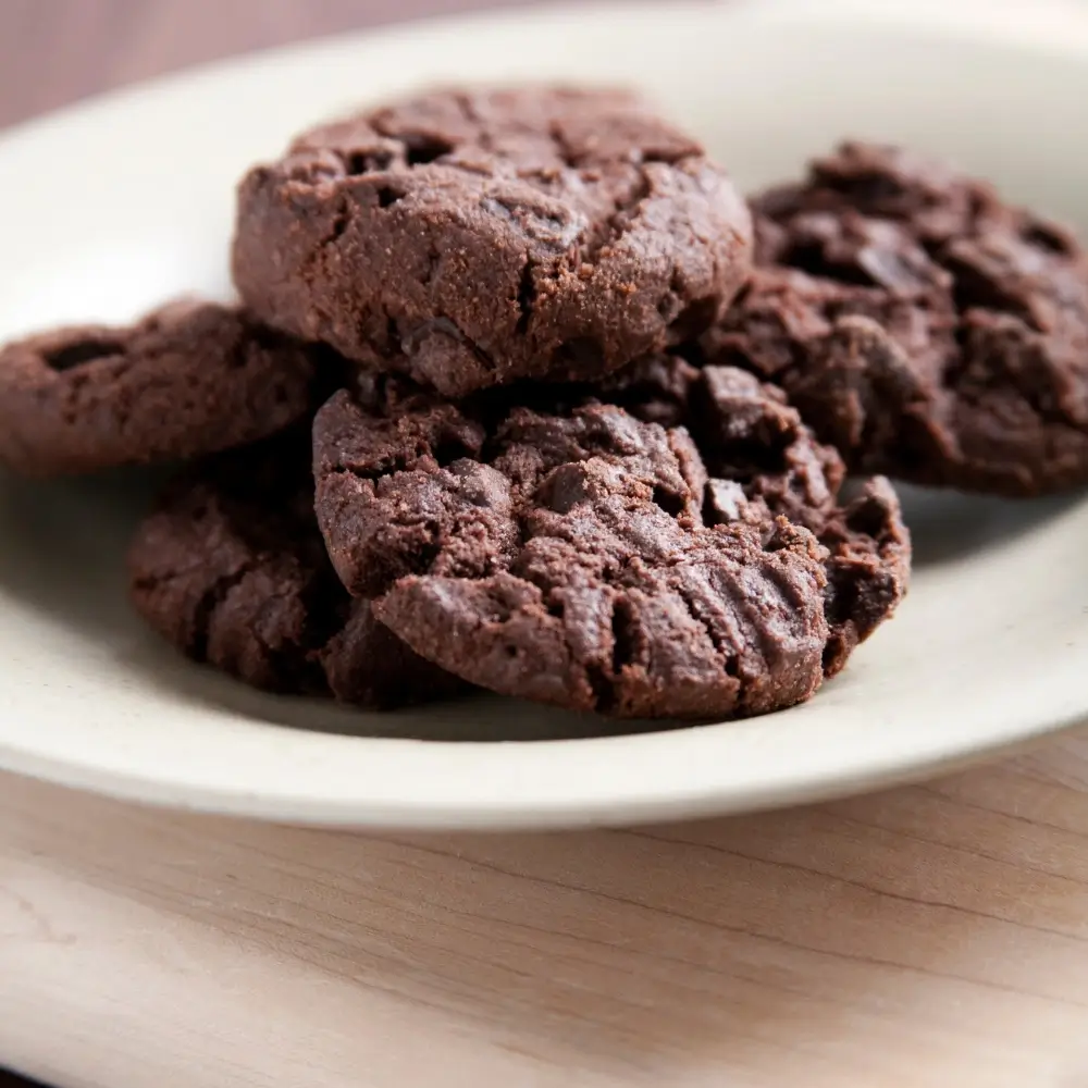 A plate of double chocolate cookies, rich and chewy with gooey chocolate chunks, perfect for chocolate lovers.
