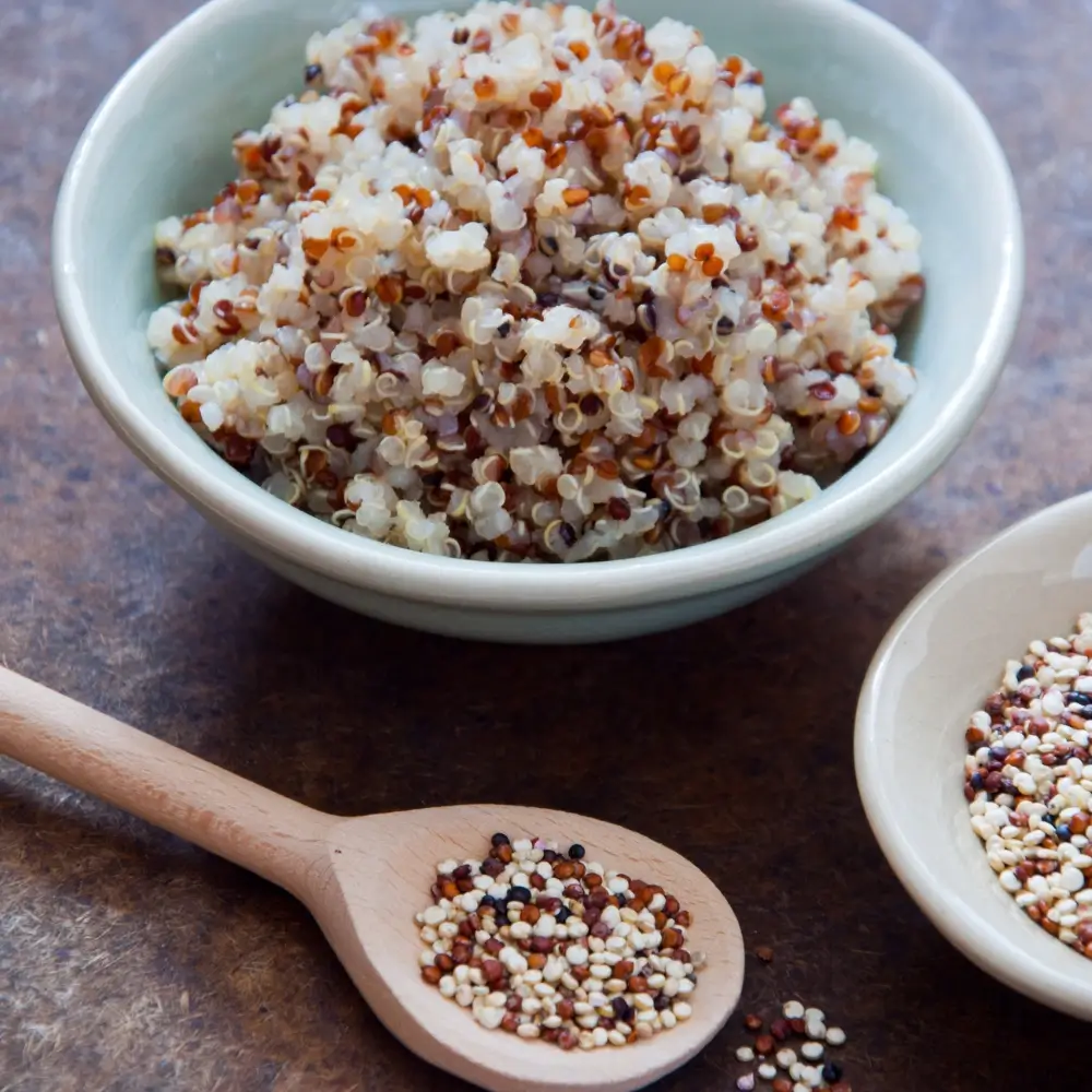 A vibrant quinoa bowl filled with fresh vegetables, protein, and a flavorful dressing, perfect for a healthy meal.
