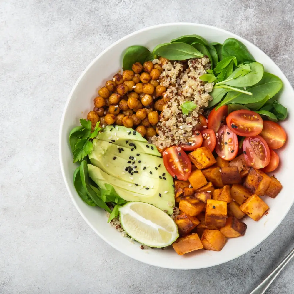 A vibrant quinoa bowl filled with fresh vegetables, protein, and a flavorful dressing, perfect for a healthy meal.