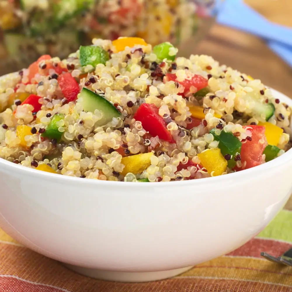 A vibrant quinoa bowl filled with fresh vegetables, protein, and a flavorful dressing, perfect for a healthy meal.