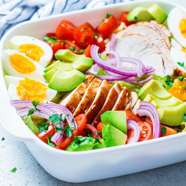 A colorful Cobb salad inspired by Chick-fil-A, topped with crispy chicken, fresh vegetables, cheese, and a tangy dressing.