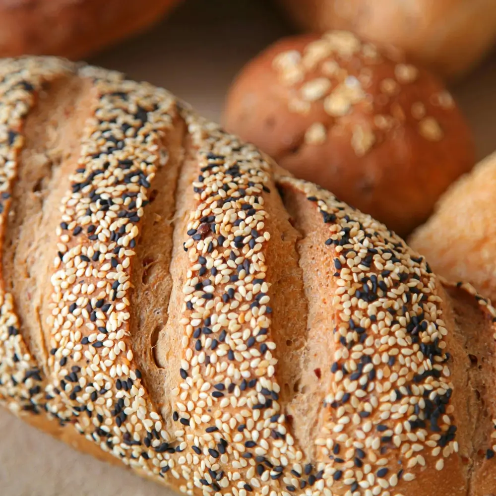 Multigrain Bread Recipe: A loaf of freshly baked, with a hearty texture and topped with seeds.