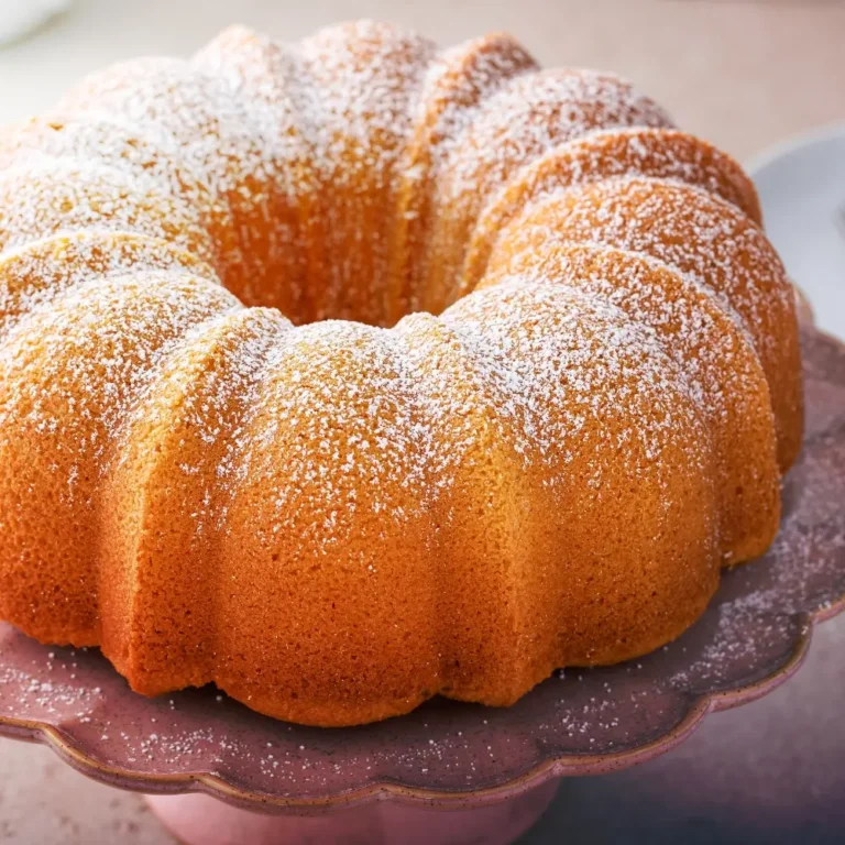 A slice of moist vanilla pound cake, golden brown with a soft and tender crumb.