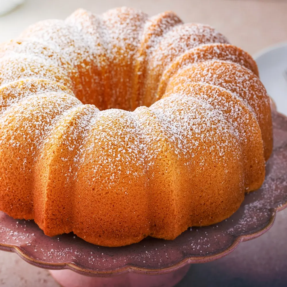 A slice of moist vanilla pound cake, golden brown with a soft and tender crumb.