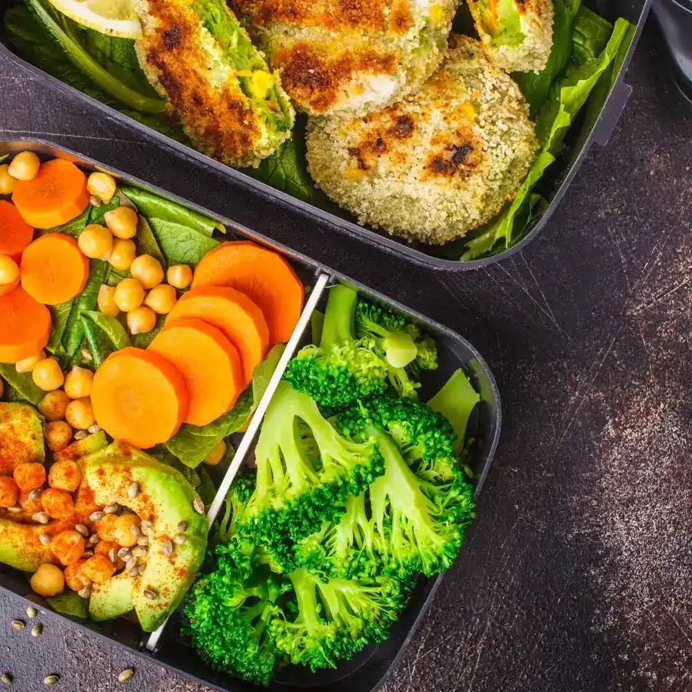 A selection of colorful vegetarian meal prep dishes, featuring fresh vegetables, grains, and plant-based proteins in neat containers.