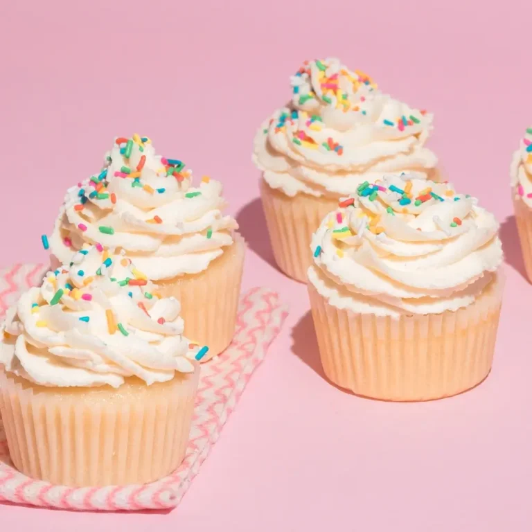 A swirl of creamy cream cheese frosting on top of a cake, smooth and fluffy with a rich texture.